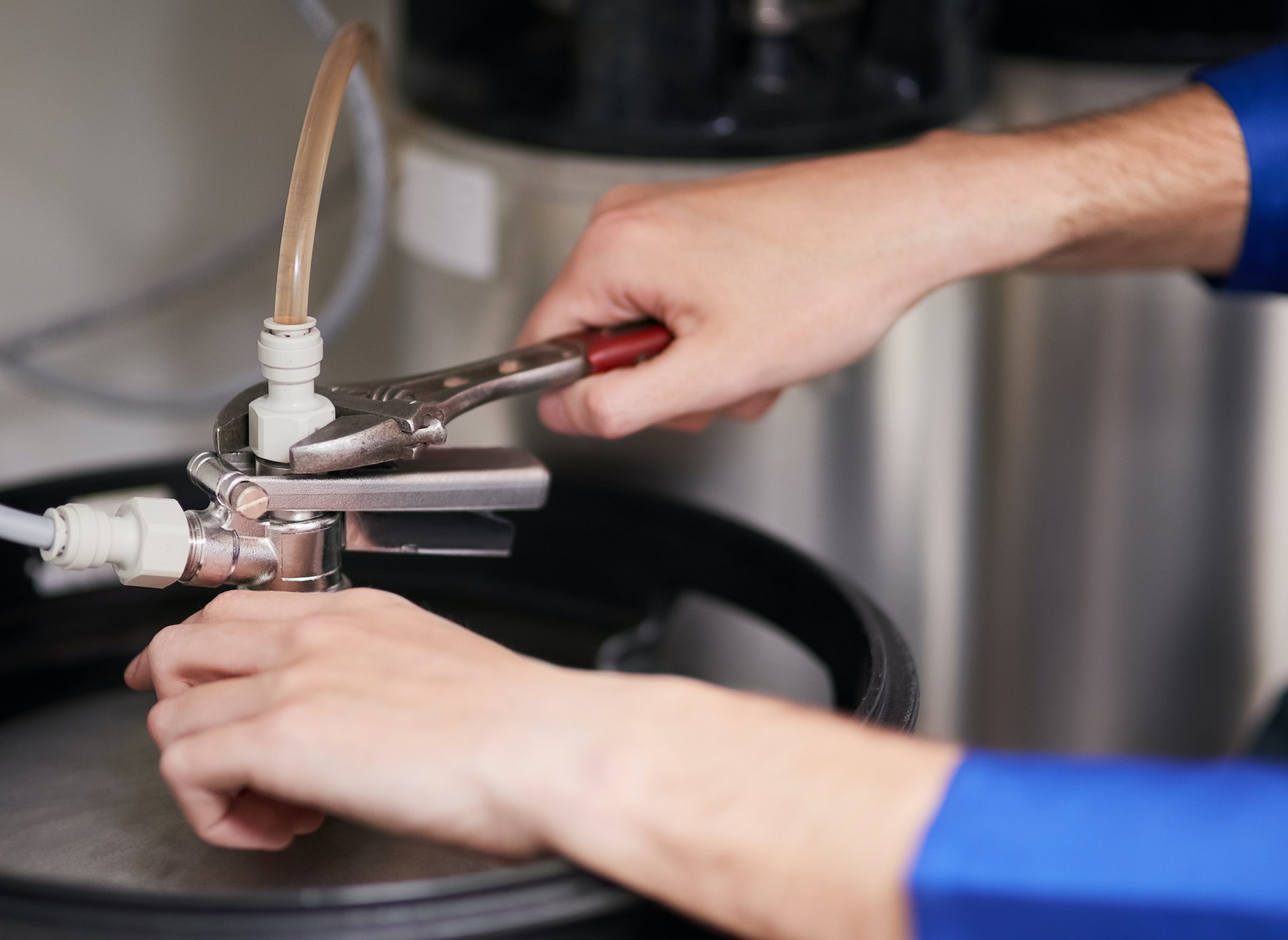 Cropped shot of a handyman repairing a pipe on a water heater